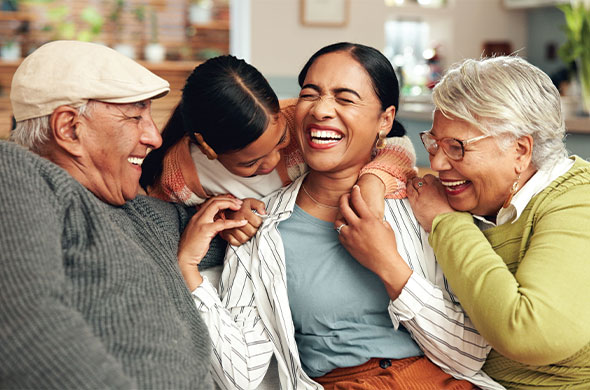 portrait of multigenerational family laughing on the couch together indexed universal life insurance